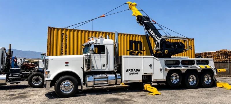 Heavy-duty rotator lifting yellow shipping container