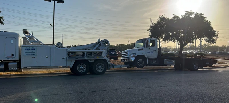 Heavy-duty wrecker towing a medium-duty truck in Lockhart