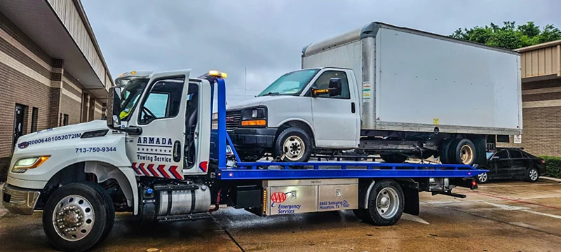 Commercial flatbed carrying white box truck in Kyle TX
