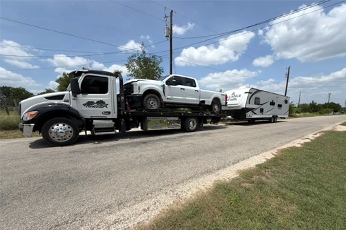 Armada Towing Service vehicle towing with flatbed truck and camper trailer