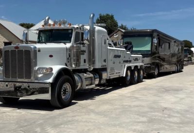 Armada Towing Service heavy wrecker towing black motor coach