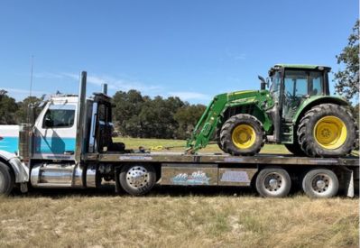 Armada Towing Service transporting John Deere farm tractor
