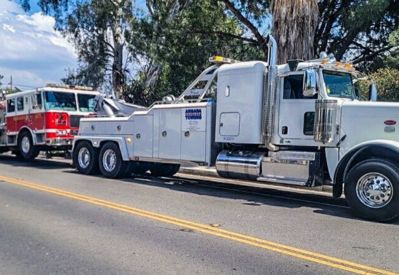 Armada Towing Service heavy-duty wrecker towing emergency fire truck