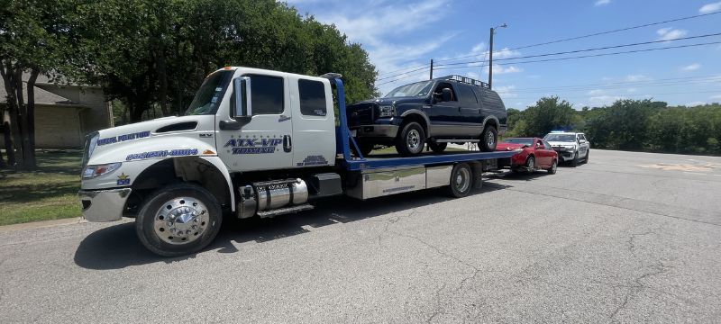Armada Towing Service flatbed towing dark SUV in Austin