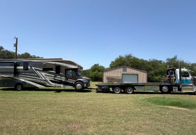 Armada Towing Service Class A motorhome towing with flatbed truck