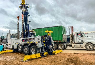 Armada Towing Service rotator setting green steel shipping container