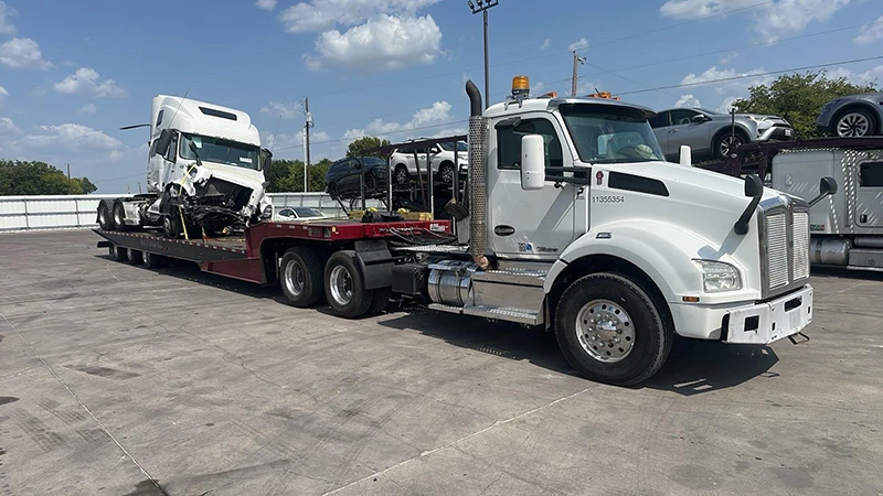 Armada Towing Service heavy recovery transporting damaged semi-truck cab