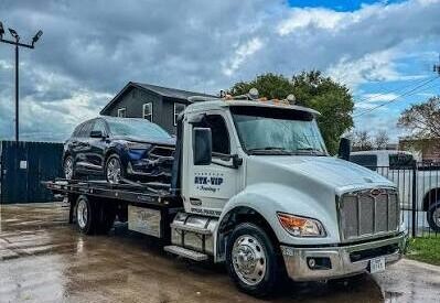 Armada Towing Service accident towing dark sedan on flatbed