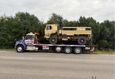 Armada Towing Service transporting tactical military vehicle